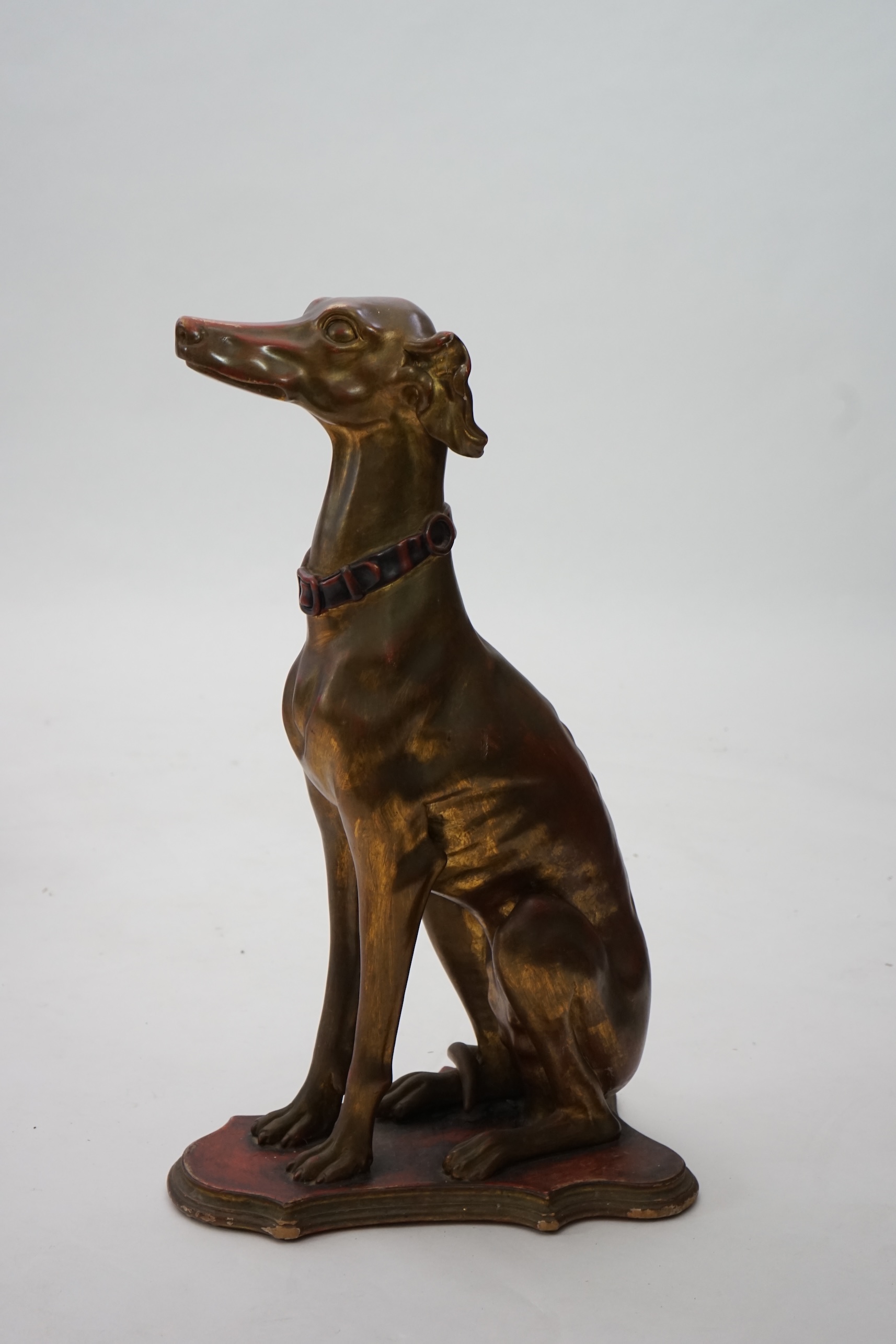 A 20th century Italian gilt and painted model of a seated Greyhound